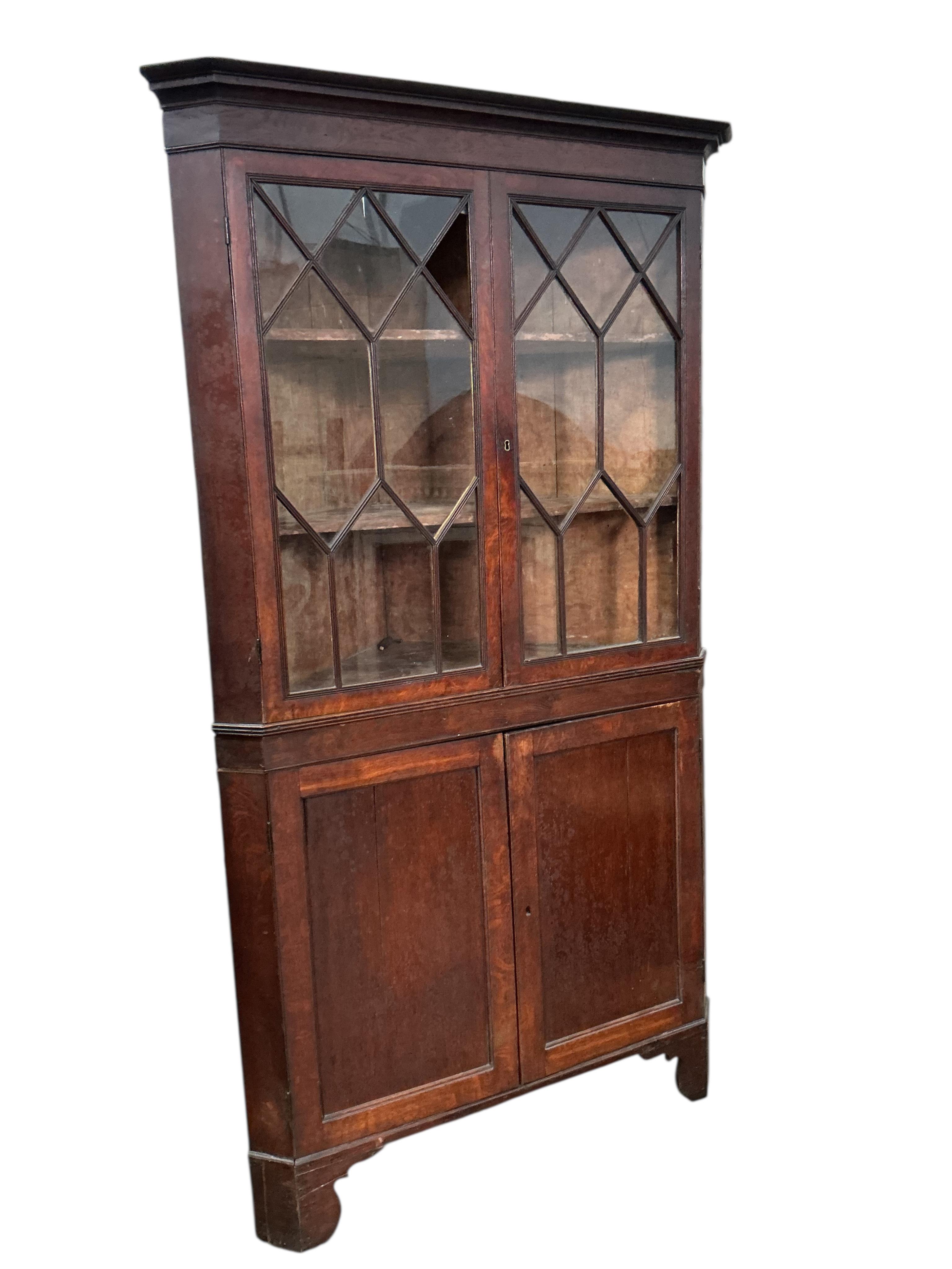 A George III oak standing corner cupboard (one glass panel missing), width 104cm, depth 57cm, height 200cm